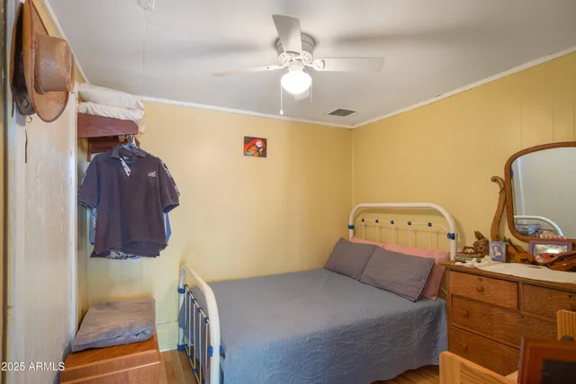 a spacious bedroom with a bed and a flat screen tv