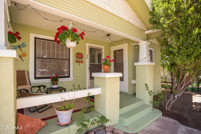 a front view of house with yard outdoor seating and flowers