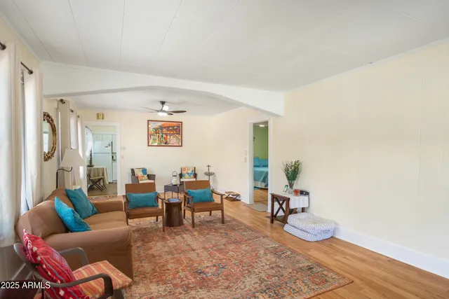 a living room with furniture and wooden floor