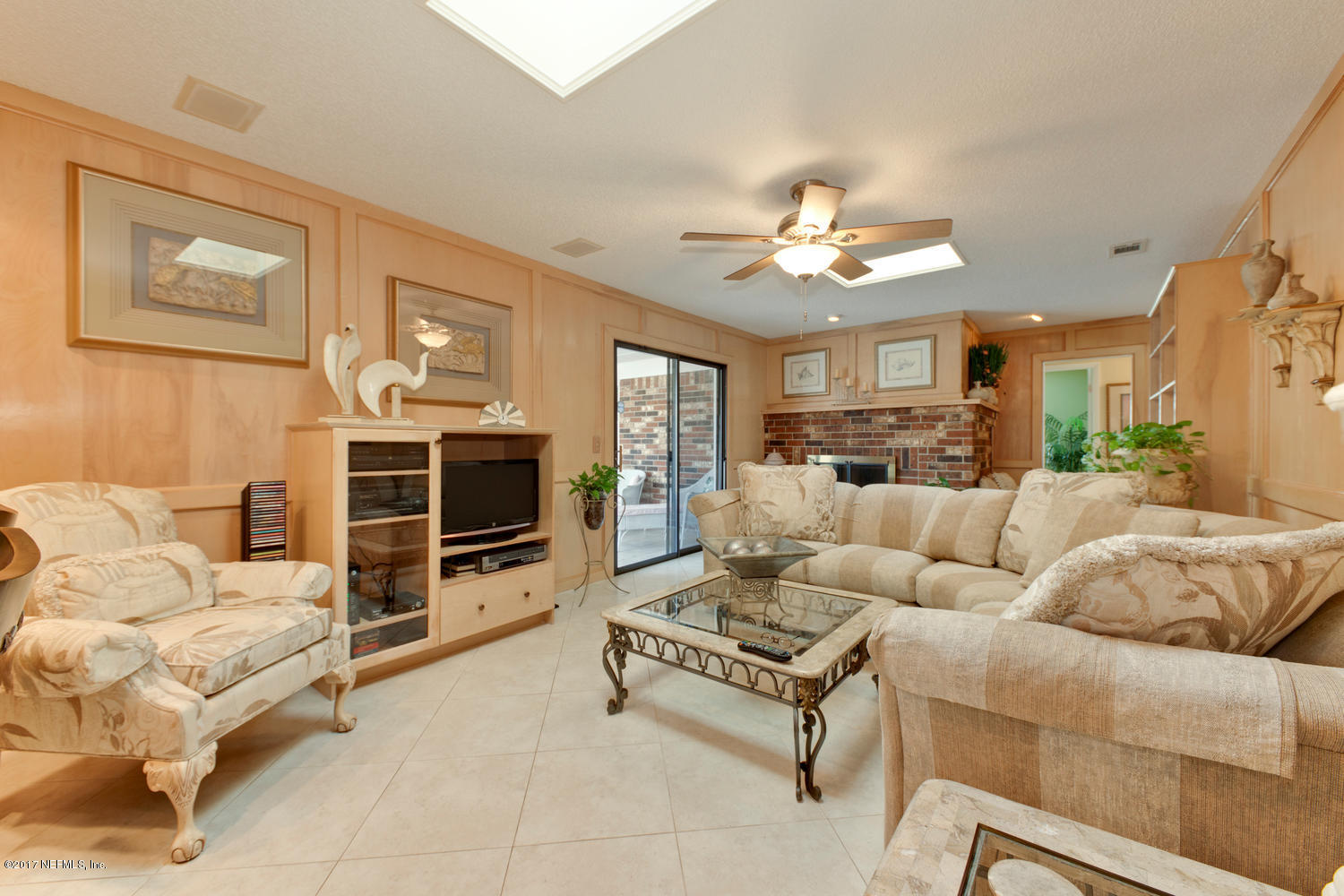 4 Amberjack Road Ponte Vedra Beach, FL 32082 - Photo 13 of 32 a living room with furniture a chandelier and a flat screen tv