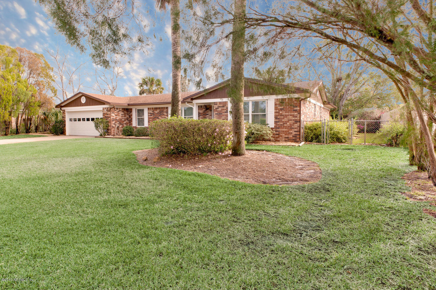 4 Amberjack Road Ponte Vedra Beach, FL 32082 - Photo 4 of 32 a front view of a house with a garden and trees