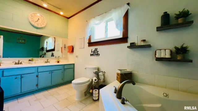 a white bath tub sitting next to a white toilet