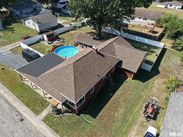 an aerial view of a house with a yard