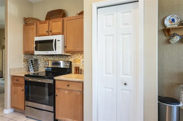 a kitchen with stainless steel appliances granite countertop a stove microwave and cabinets