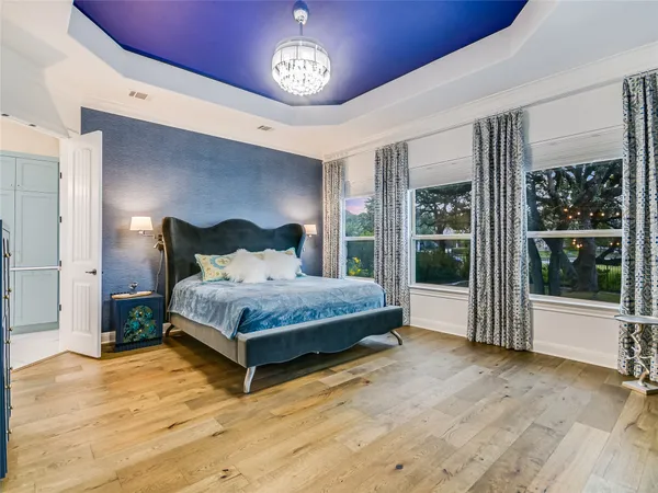a bedroom with a bed lamp and window