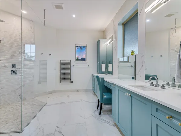 a spacious bathroom with a sink a mirror and a shower
