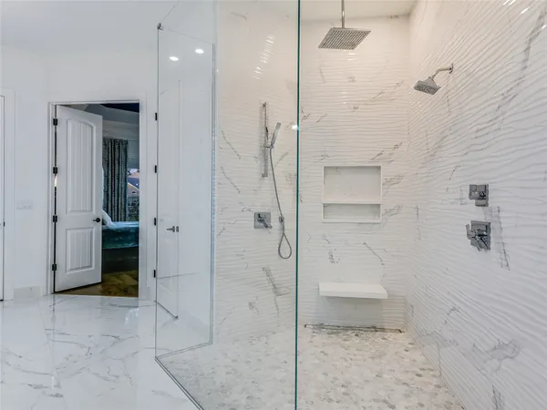 a bathroom with a shower and a glass door