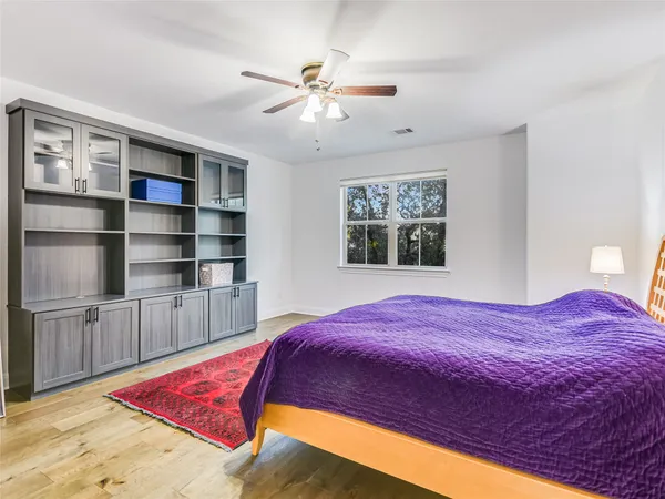 a bedroom with a large bed and a chandelier