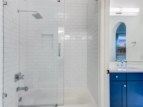 a bathroom with a shower and a sink
