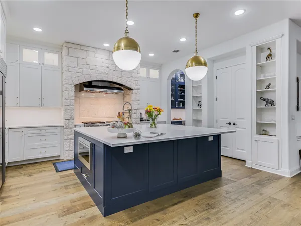 a kitchen with a sink cabinets and wooden floor