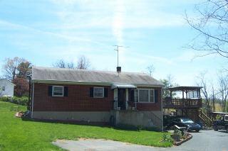 1013 Goodview Road Goodview, VA 24095 - Photo 1 of 1 a front view of a house with a yard