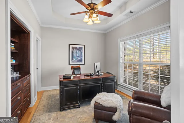 a room with a table chairs and a window