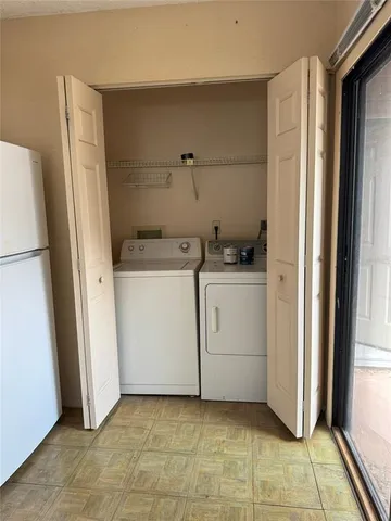 a utility room with cabinets washer and dryer