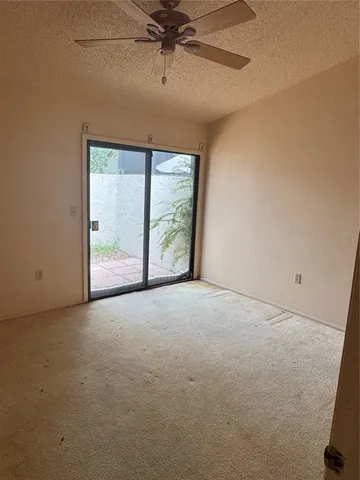 an empty room with a empty space and a ceiling fan