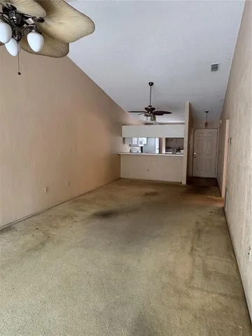 a view of a room with wooden floor and chandelier