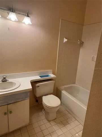 a white toilet sitting next to a bathroom sink
