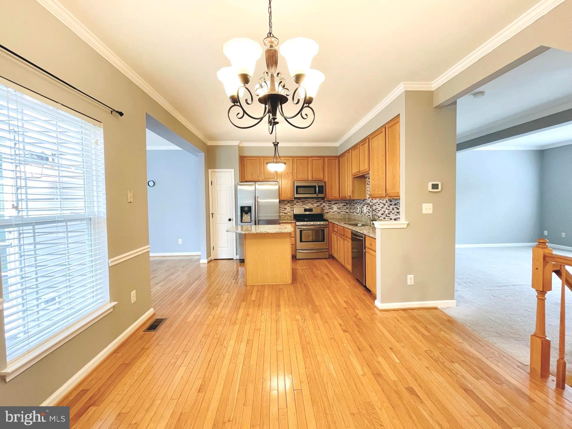 12159 Drum Salute Place Bristow, VA 20136 - Photo 9 of 36 a view of a kitchen with a sink stainless steel appliances