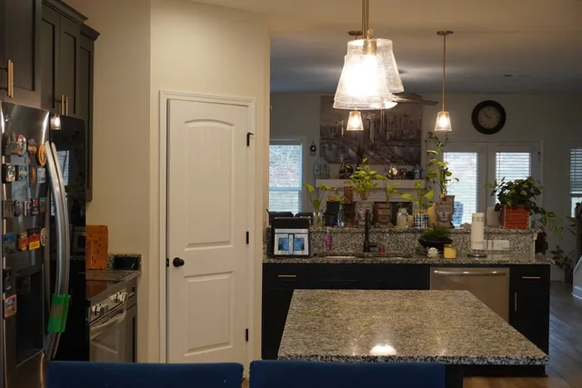 a living room with furniture and a chandelier