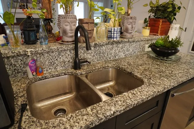 a living room with furniture a couch and kitchen view