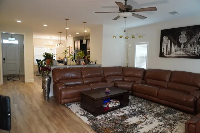 a living room with furniture a fireplace and a window