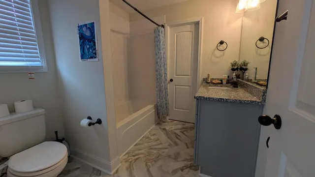 a bedroom with bed and wooden floor