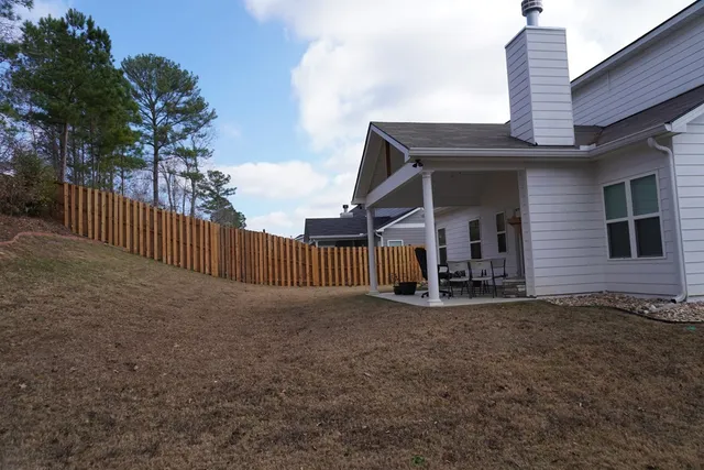 a view of a house with backyard porch and sitting area