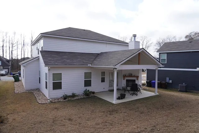 a kitchen with stainless steel appliances granite countertop a refrigerator a sink a stove and a wooden floors