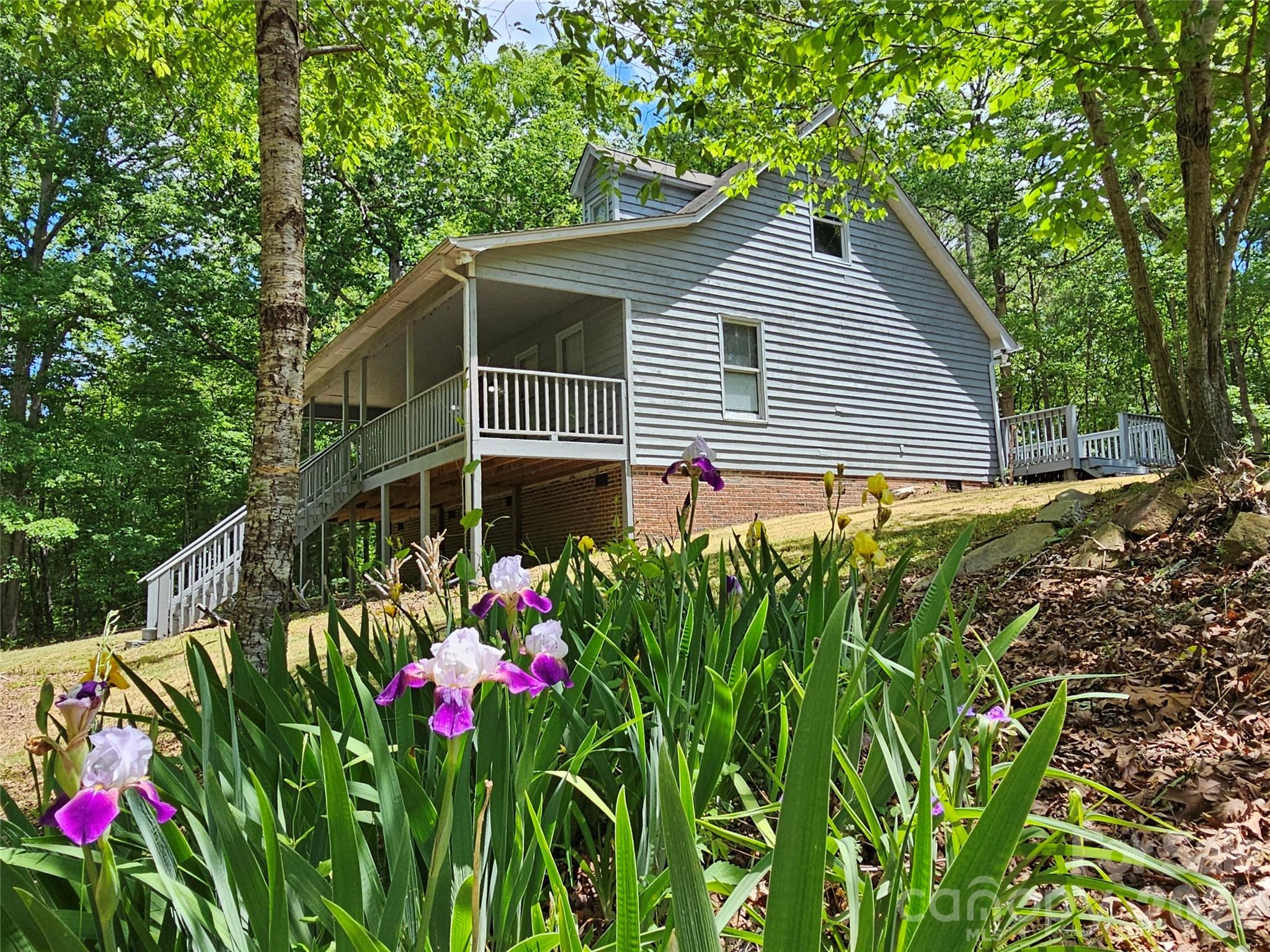 5692 S-141 Great Falls, SC 29055 - Photo 1 of 48 a backyard of a house with flower plants