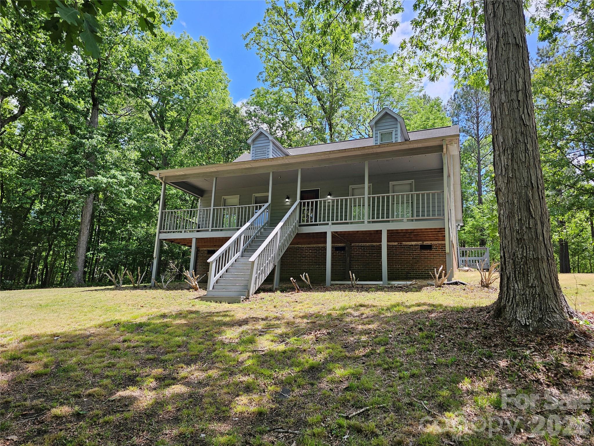 5692 S-141 Great Falls, SC 29055 - Photo 11 of 48 a view of a house with a large window and a tree