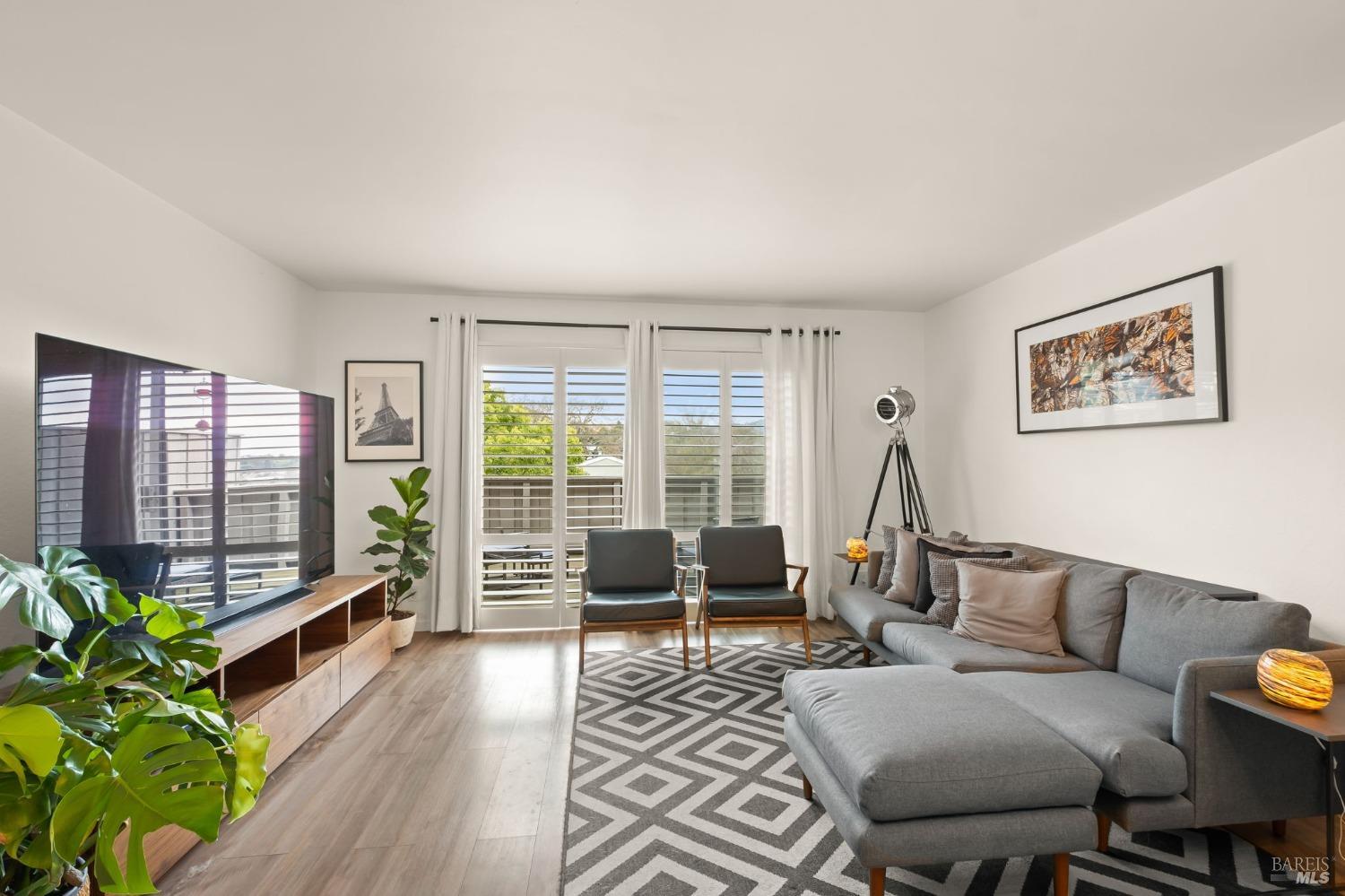 Mid-Century Modern Style! Entertain effortlessly in the spacious Open Living Room and Dining Area, flowing seamlessly onto a generous Balcony, ideal for gatherings and soirées.