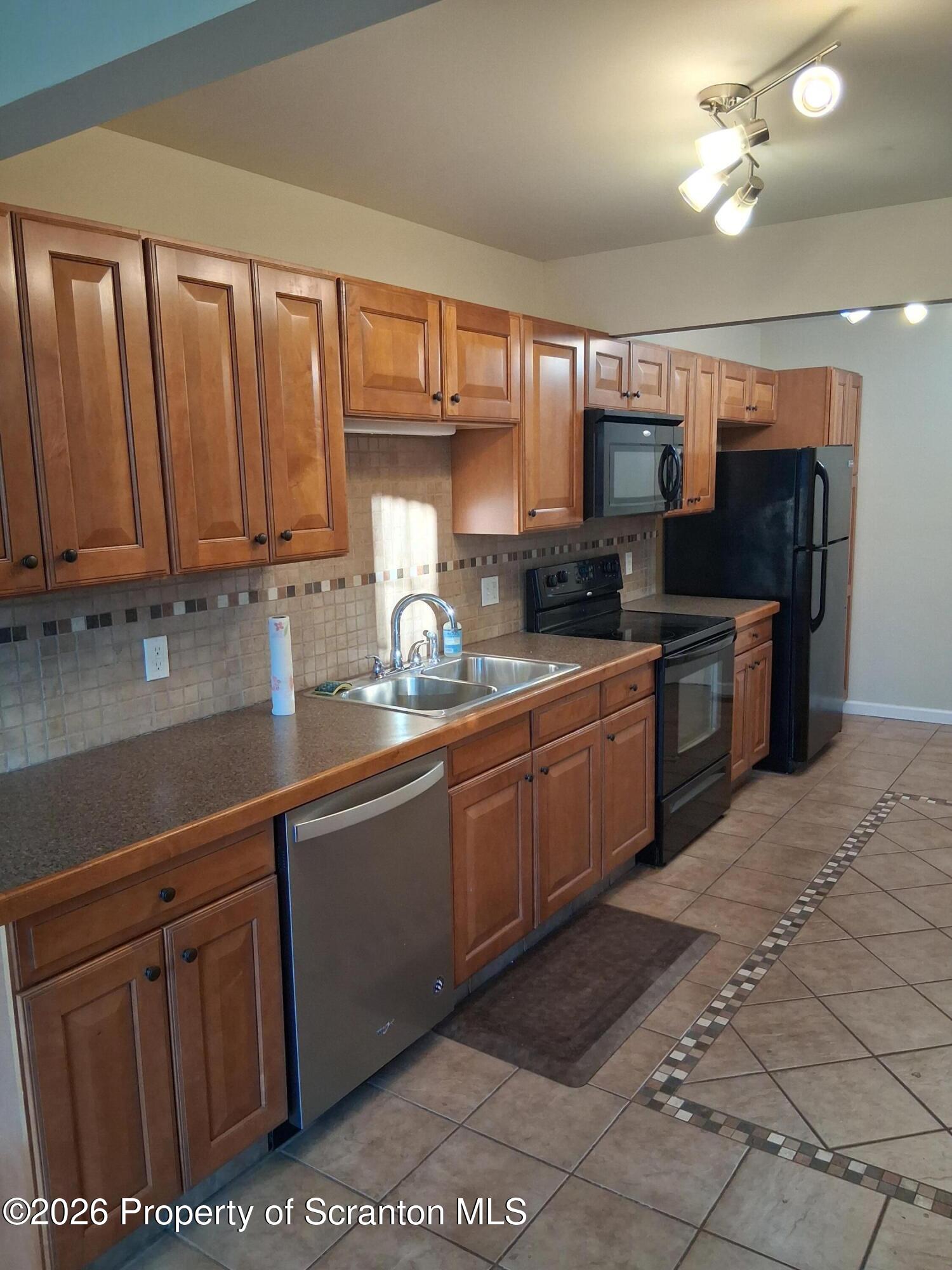 512 South Keyser Avenue Scranton, PA 18504 - Photo 12 of 42 a kitchen with stainless steel appliances granite countertop a stove a sink and a microwave