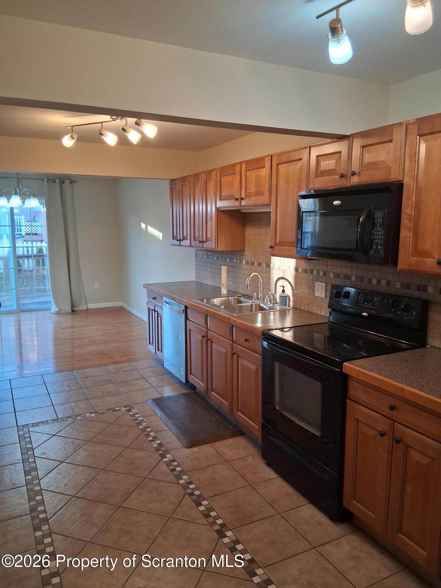 512 South Keyser Avenue Scranton, PA 18504 - Photo 13 of 42 a kitchen with stainless steel appliances granite countertop a stove a sink and a microwave