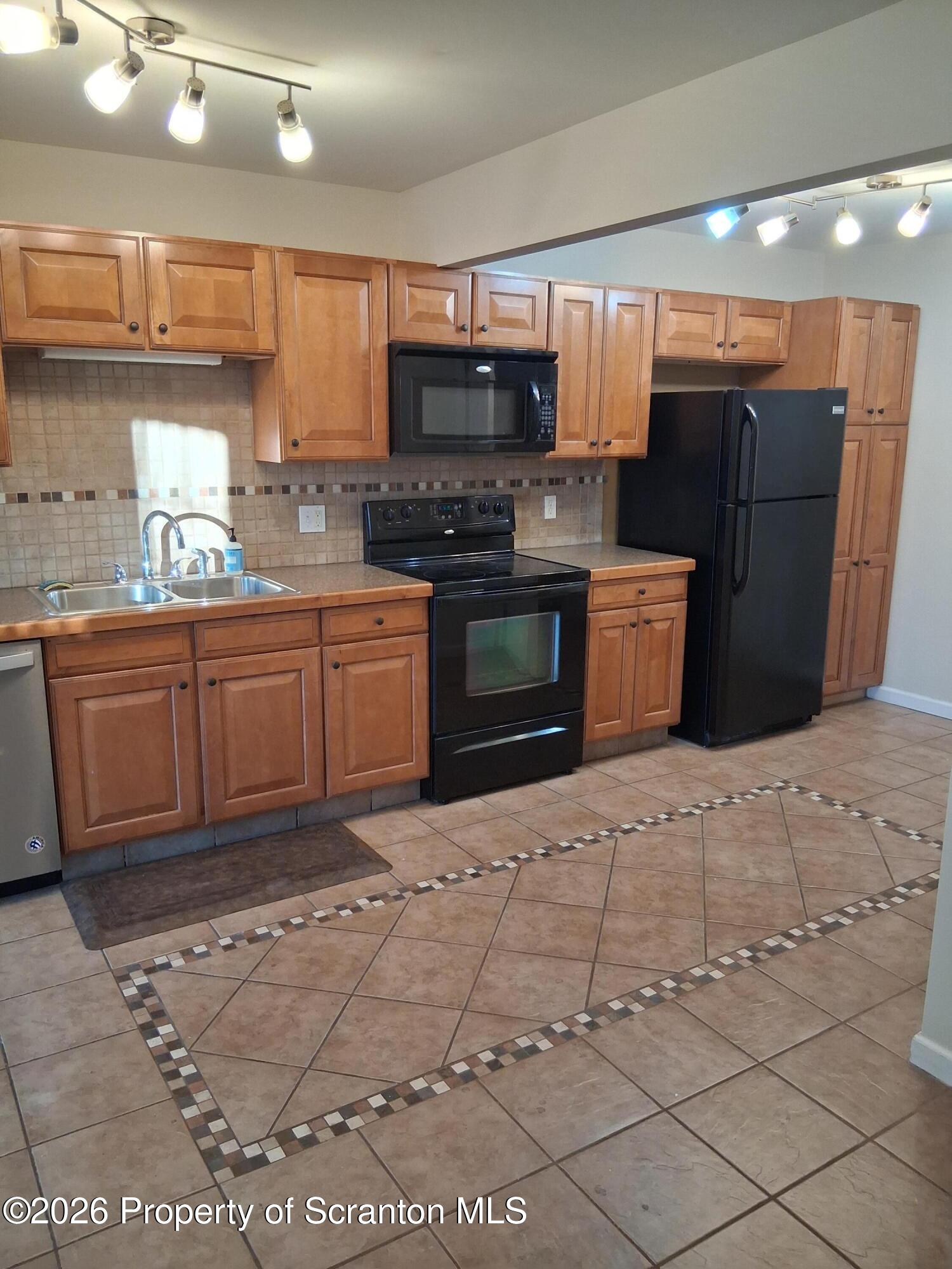 512 South Keyser Avenue Scranton, PA 18504 - Photo 14 of 42 a kitchen with stainless steel appliances granite countertop a stove a sink and a microwave