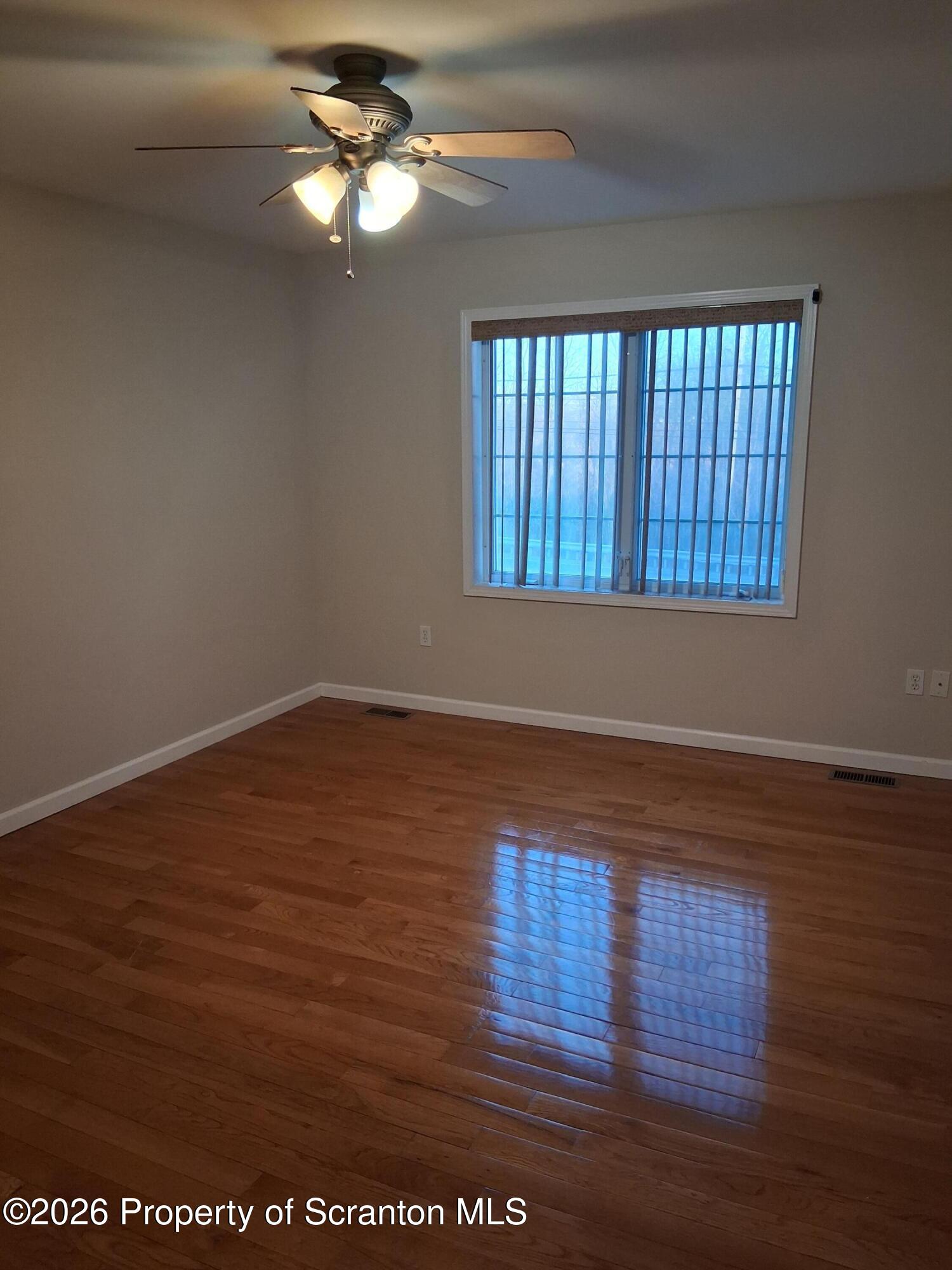 512 South Keyser Avenue Scranton, PA 18504 - Photo 30 of 42 a view of empty room with wooden floor and fan