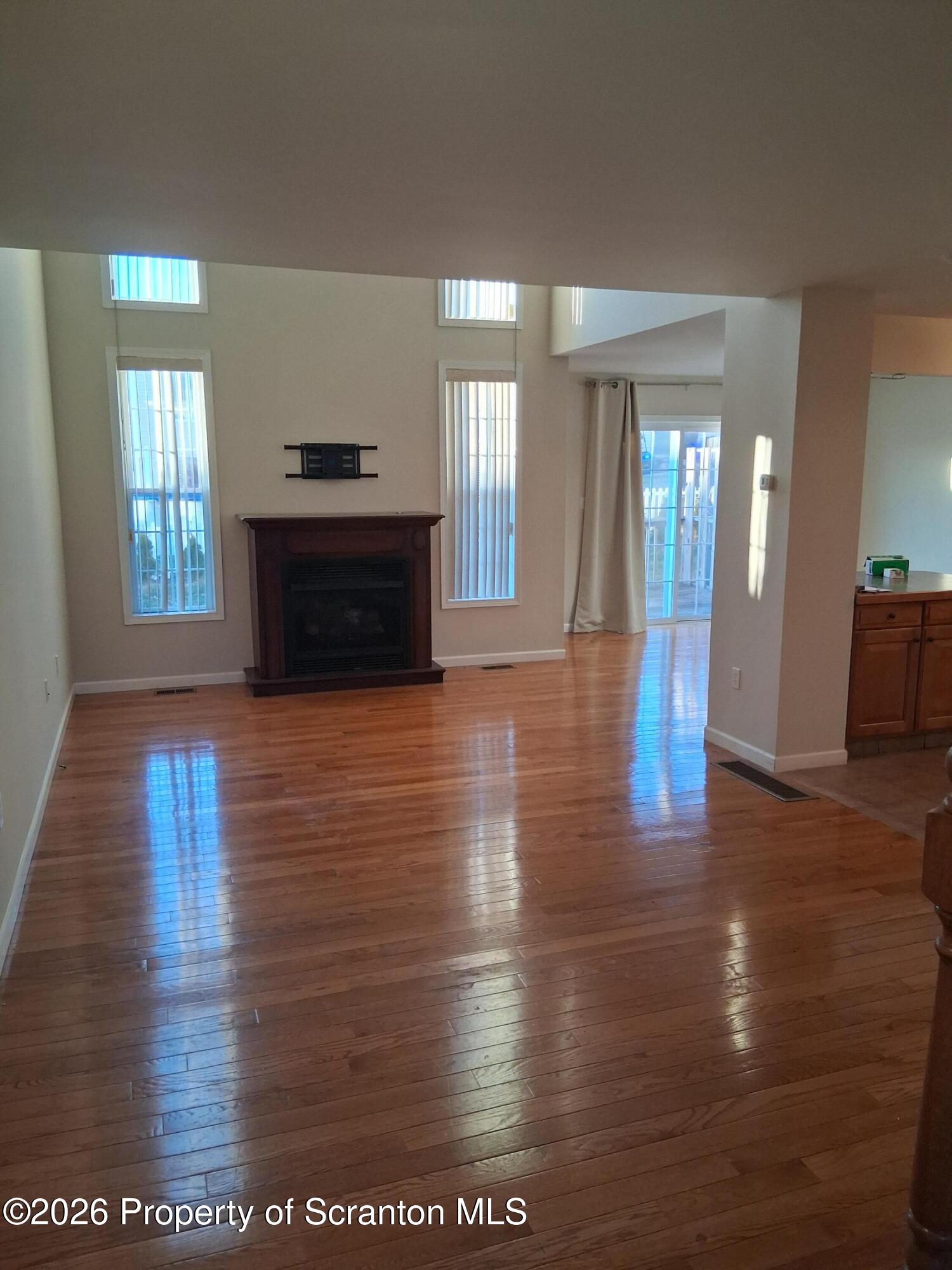 512 South Keyser Avenue Scranton, PA 18504 - Photo 8 of 42 a view of an empty room with window and wooden floor