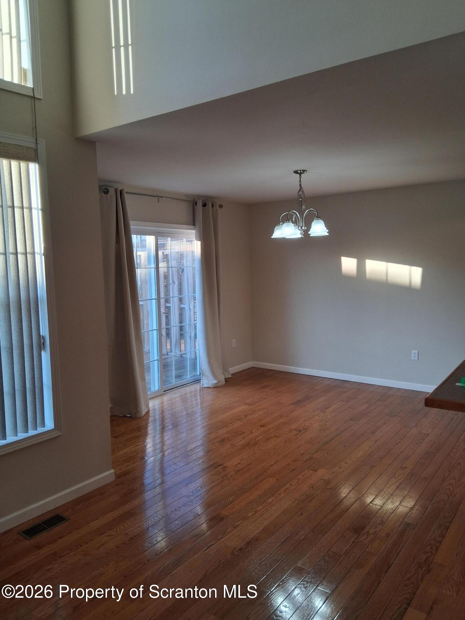 512 South Keyser Avenue Scranton, PA 18504 - Photo 9 of 42 a view of an empty room with wooden floor and a window
