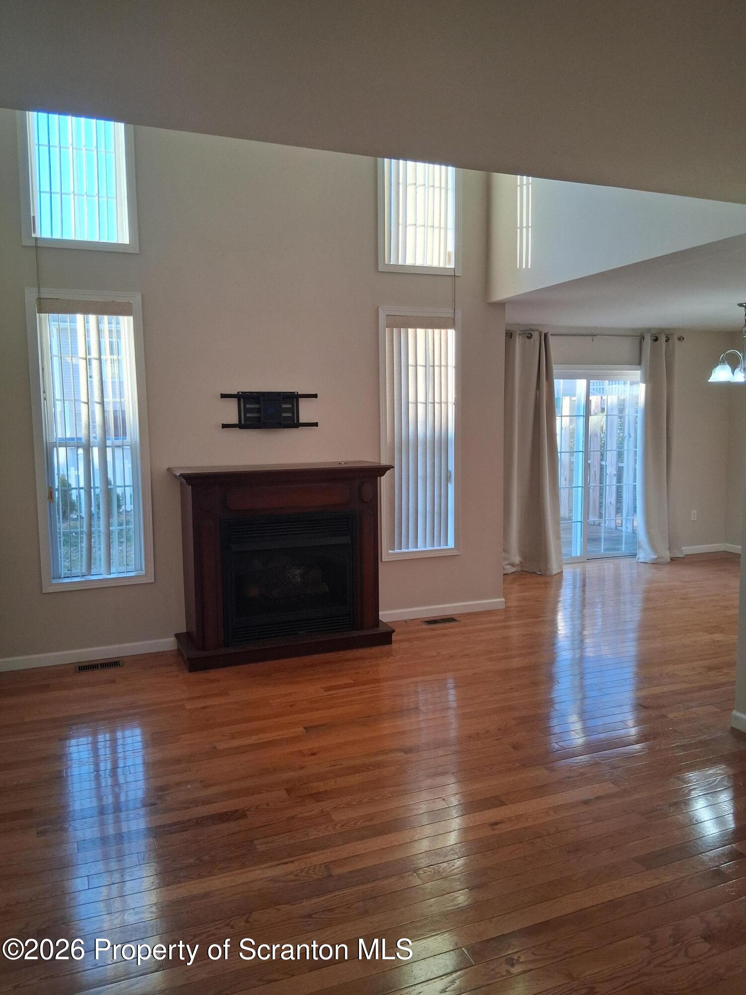512 South Keyser Avenue Scranton, PA 18504 - Photo 10 of 42 a view of an empty room with wooden floor and a window