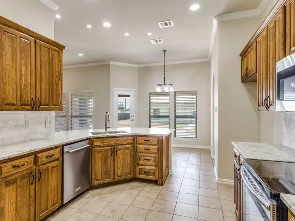 a kitchen with a sink counter top space appliances and cabinets