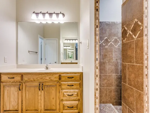 a bathroom with a mirror and a shower