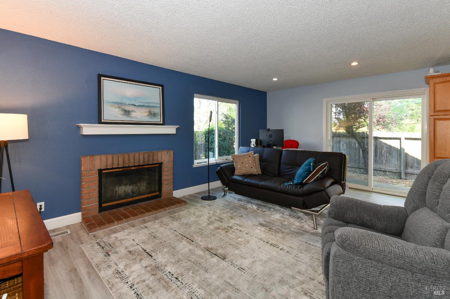 1106 Noyo Place Santa Rosa, CA 95401 - Photo 6 of 22 The family room features a cozy fireplace and slider to the backyard.