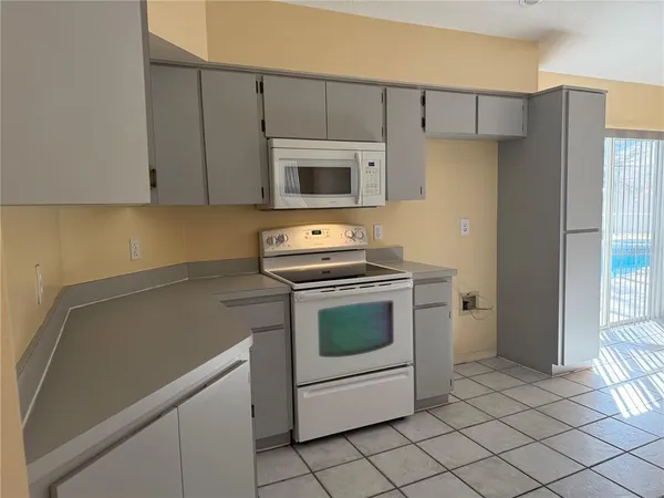 a kitchen with a stove cabinets and a refrigerator