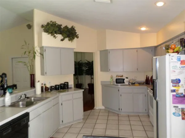 a kitchen with cabinets and appliances
