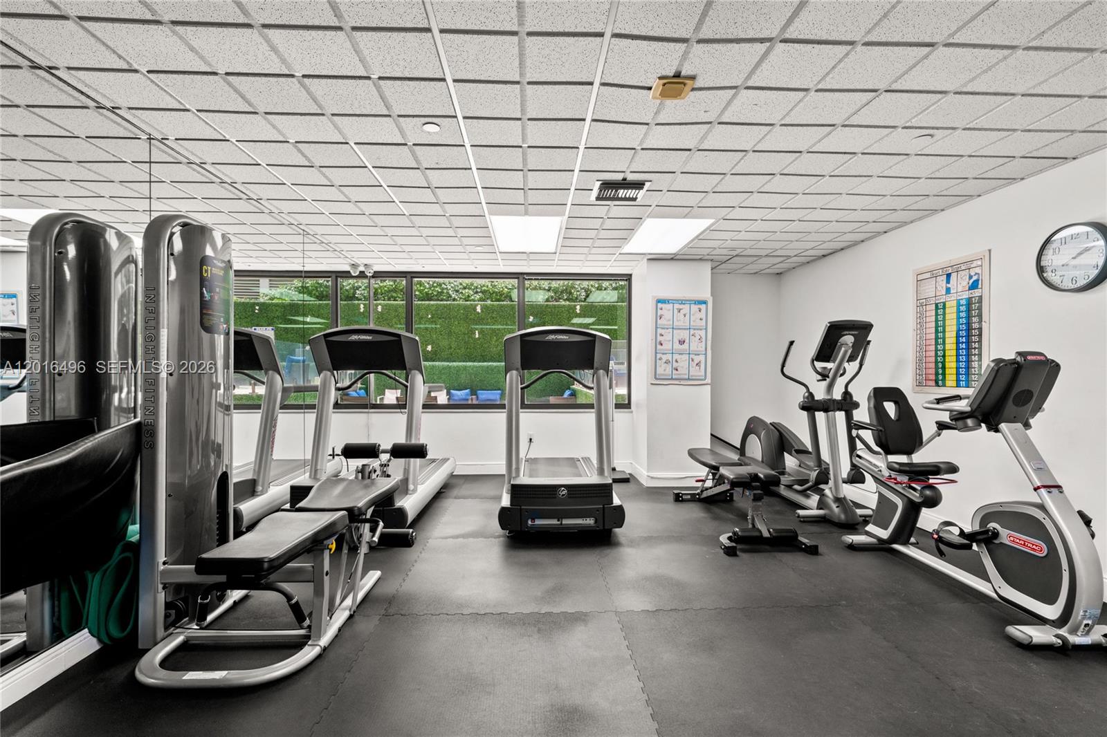 9455 Collins Avenue, Unit 310 Surfside, FL 33154 - Photo 11 of 19 a room with gym equipment and large mirror