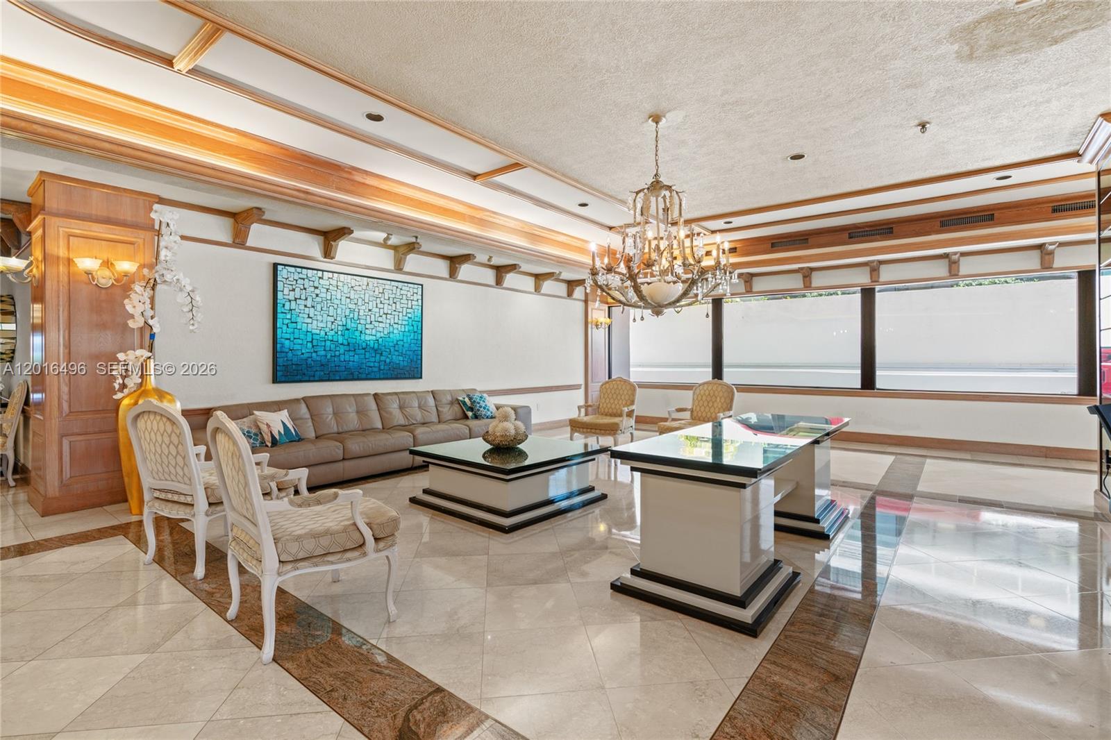 9455 Collins Avenue, Unit 310 Surfside, FL 33154 - Photo 12 of 19 a living room with furniture and a chandelier