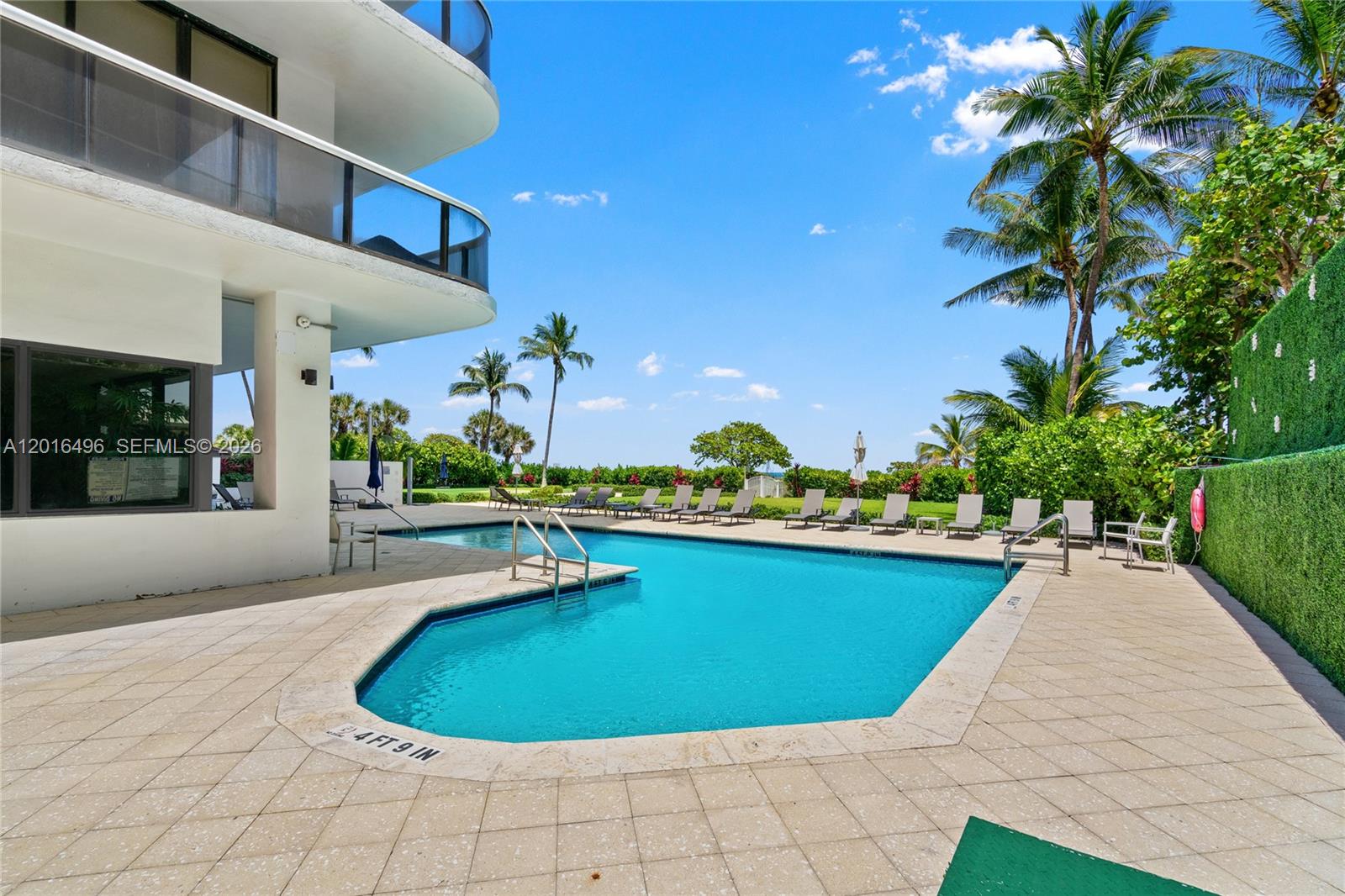 9455 Collins Avenue, Unit 310 Surfside, FL 33154 - Photo 6 of 19 a view of a swimming pool with an outdoor seating