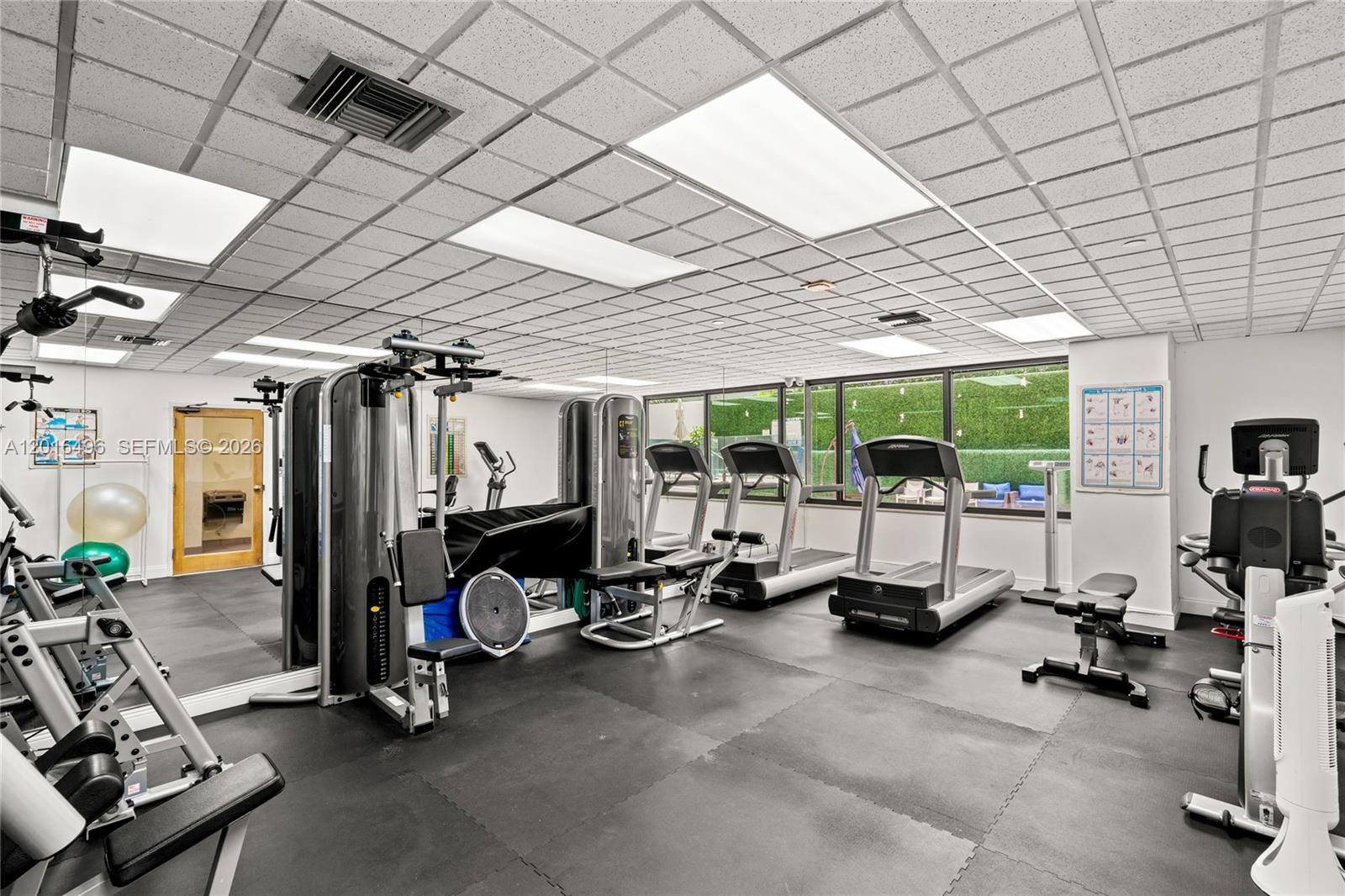 9455 Collins Avenue, Unit 310 Surfside, FL 33154 - Photo 10 of 19 a view of a room with gym equipment