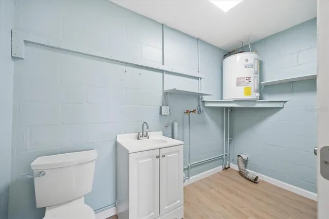 a bathroom with a toilet sink and mirror