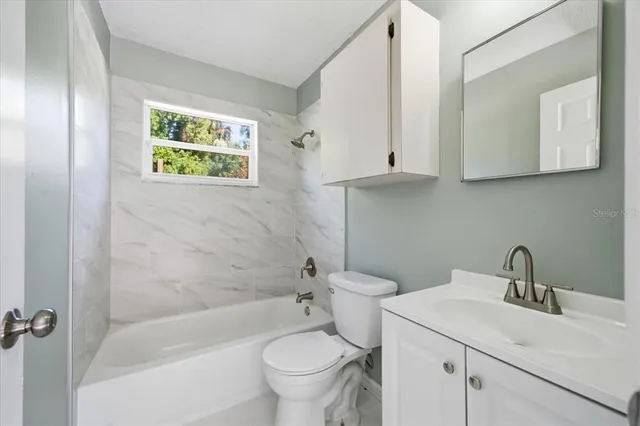 a bathroom with a sink a toilet and a bathtub