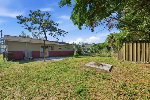 a view of backyard with outdoor seating and green space