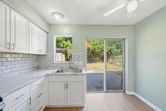 a kitchen with a sink and large window